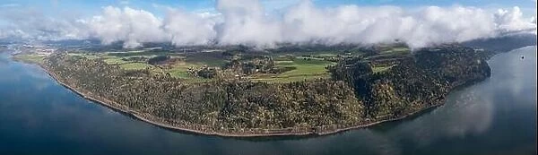 Clouds drift over the Columbia River which runs between Oregon and Washington. The scenic Columbia River Gorge runs for over 80 miles