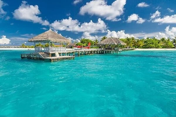 Exotic Paradise. Travel, tourism and vacations concept. Tropical resort and infinity blue sea, Maldives or French Polynesia. Amazing summer beach view