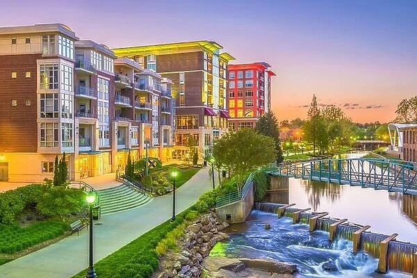 Greenville, South Carolina, USA downtown cityscape on the Reedy River at dusk
