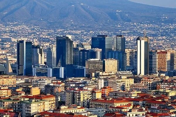 Naples, Italy with the financial district skyline under Mt. Vesuvius at twilight
