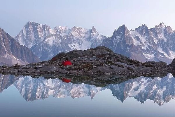 Red tent on Lac Blanc lake coast in France Alps. Monte Bianco mountains range on background. Landscape photography, Chamonix