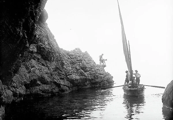 Bathers on board a sailing boat in a cave on the Island of Elba