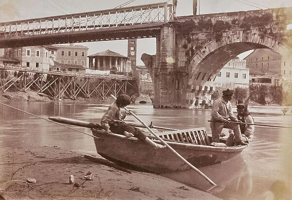 Boating on the river under the bridge Emilio (today Ponte Rotto) in Rome connected to the left bank of the Tiber with a metal walkway supported by ropes. In the background the Temple of Hercules Victor (called temple of Vesta), down scaffolding for the construction of the embankments and the fornix of the Cloaca Maxima