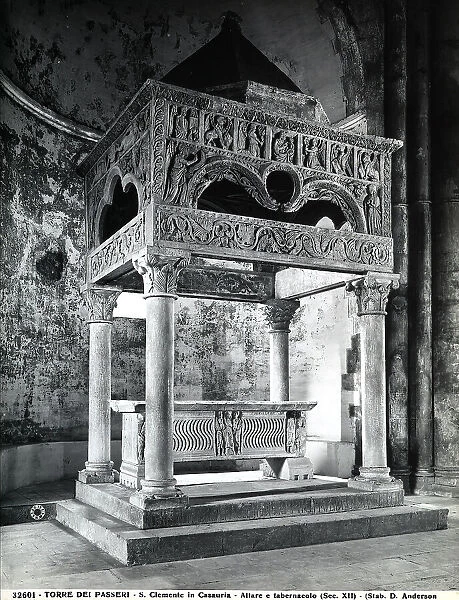 Ciborium and altar of the church of S. Clemente in Casauria, Torre De Passeri. The ciborium consists of four columns with a pyramid cover. The frontispieces are scuplted. The Annunciation is represented on the foremost one.The altar is in the form of a sarcophagus with images