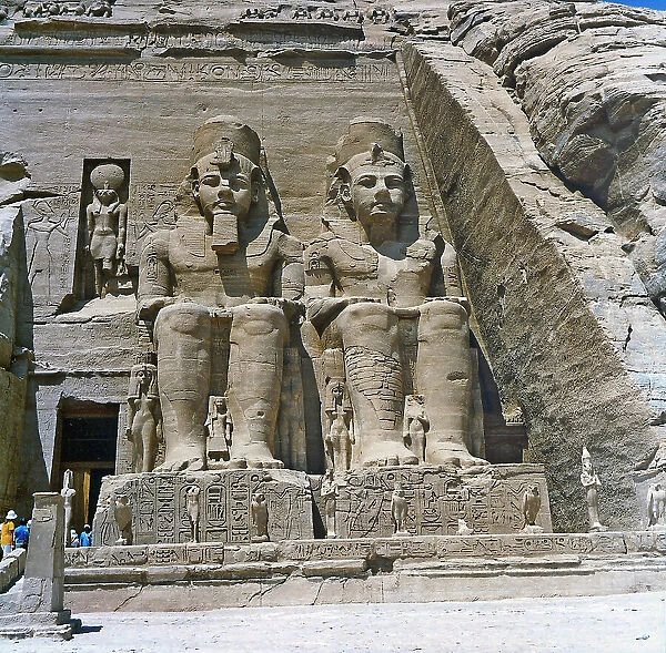 Two colossal statues of Ramses II on the right side of the faade of the Great Temple of Abu Simbel, in Lower Nubia. The temple is seen in its present location after being moved to make way for the creation of Nasser Lake