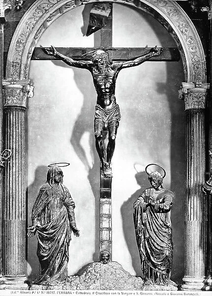Crucifix with the Madonna and St. John the Evangelist. Sculpture located in the right transept of the Cathedral of Ferrara