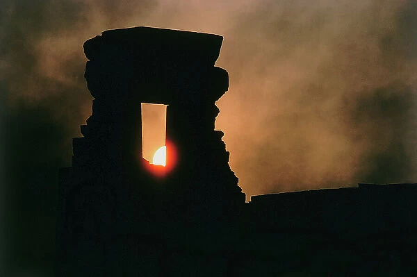 Dandara. The fireball of the sun setting over the ruins of the Temple of Hathor