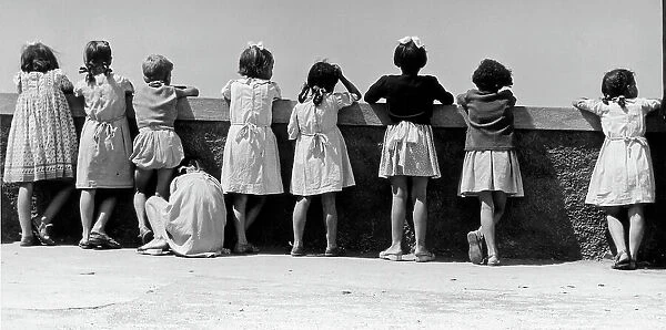 Group of children leaning against a parapet