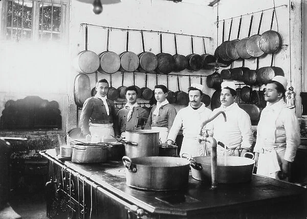 Group portrait of the cooks and waiters of the restaurant Cinotto in Turin, taken in the kitchen