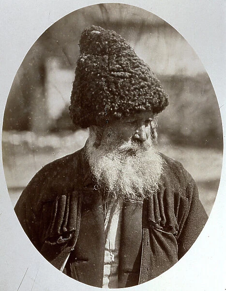 Half-length portrait of an elderly inhabitant of the Caucasus. He is wearing a large lambskin hat