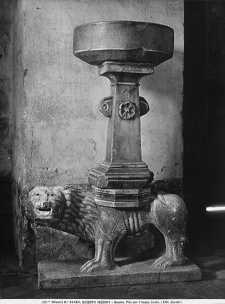 Holy water stoup obtained from a Corinthian capital, resting on a Medieval lion. It is in the cathedral of San Michele in Casertavecchia, in the province of Caserta