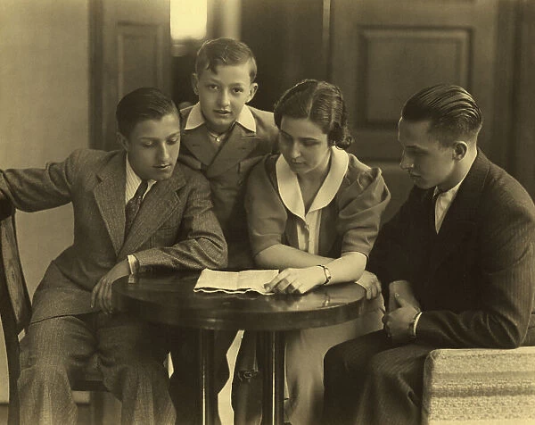 Portrait of the Gentili family, seated at a table as they read a letter