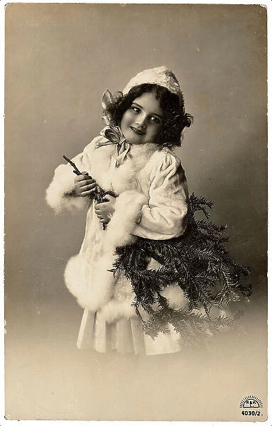 Portrait of a young little girl carrying a fir-branch tree, Christmas greeting post-card, with a personal dedication in german on the back side