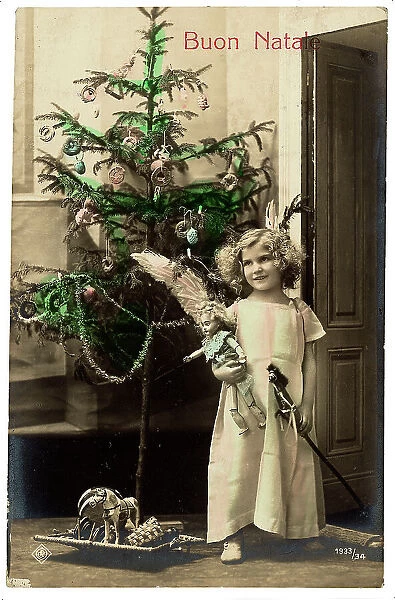 Portrait of a young little girl with her toys near the Christmas tree, Christmas greeting post-card, with a Buon Natale inscription on the front side and a personal dedication on the back side, the postage stamp indicates the date of 19th December 1910 and the city of Ferrara, Italy