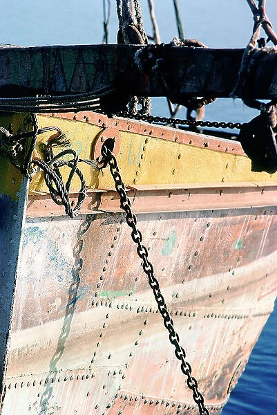 A sailor fixing the sail on the mainmast of a felucca
