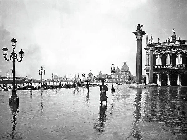 View of the lagoon from Piazzetta San Marco in the rain. The monolithic column topped by a statue of the Lion of St. Mark and the Church of Santa Maria della Salute are clearly visible