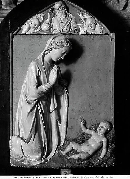 The Virgin in adoration of the Child. Glazed terracotta of the Della Robbias, located in the Gallery of Palazzo Bianco, in Genoa