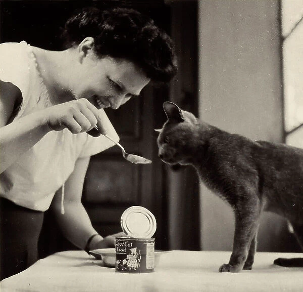 Wanda Wulz feeding her cat Pippo