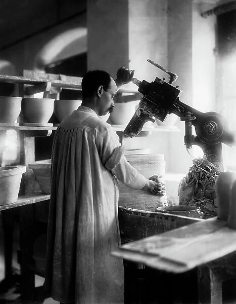 A worker in the Ginori Factory, in Doccia near Florence, portrayed during the phase of the mixture for the production of the ceramic products