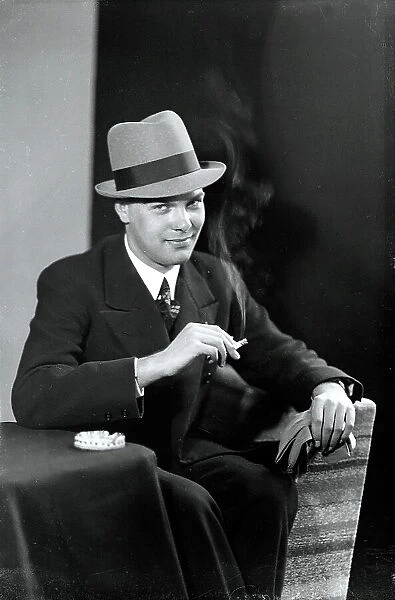 Young man in a hat with cigarette