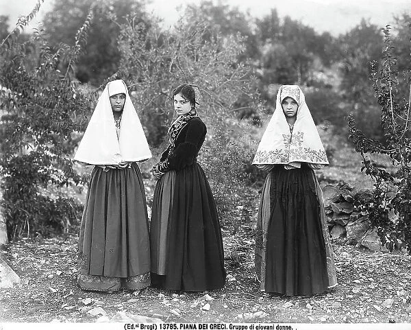 Three young women in traditional dress photographed at Piana dei Greci, today's Piana degli Albanesi, in the province of Palermo
