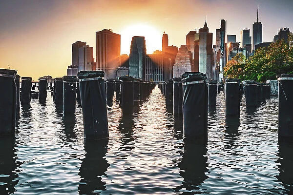 New York City, East River Manhattan, Lower Manhattan Downtown skyline at sunrise from Brooklyn Bridge Park