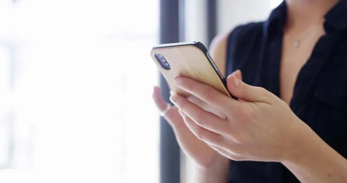 Framed Print : Hands and smartphone print, closeup office scene Framed Print : Hands and smartphone print, closeup office scene