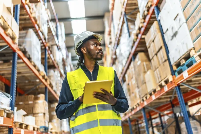 Framed Print : African Warehouse Supervisor Using Tablet Print