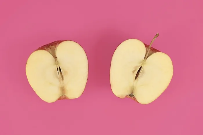 Framed Print : Apple Cut into Half Print on Pink Background Framed Print : Apple Cut into Half Print on Pink Background