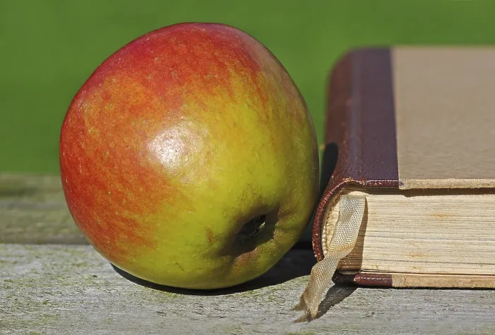 Framed Print : Apple beside an old book Print Framed Print : Apple beside an old book Print