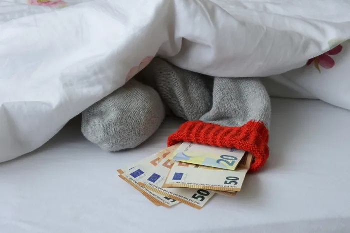 Framed Print : Banknotes in Stocking Under Duvet Print Framed Print : Banknotes in Stocking Under Duvet Print