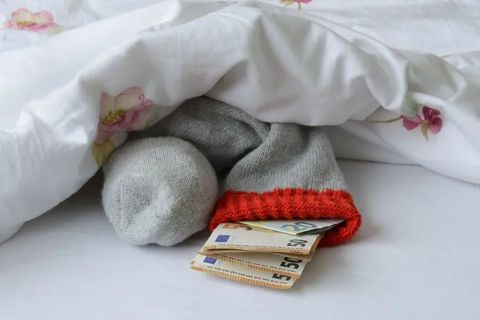 Framed Print : Banknotes in Stocking Under Duvet Print Framed Print : Banknotes in Stocking Under Duvet Print