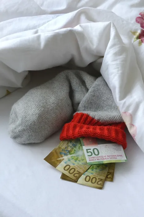 Framed Print : Banknotes in Stocking under Duvet Print