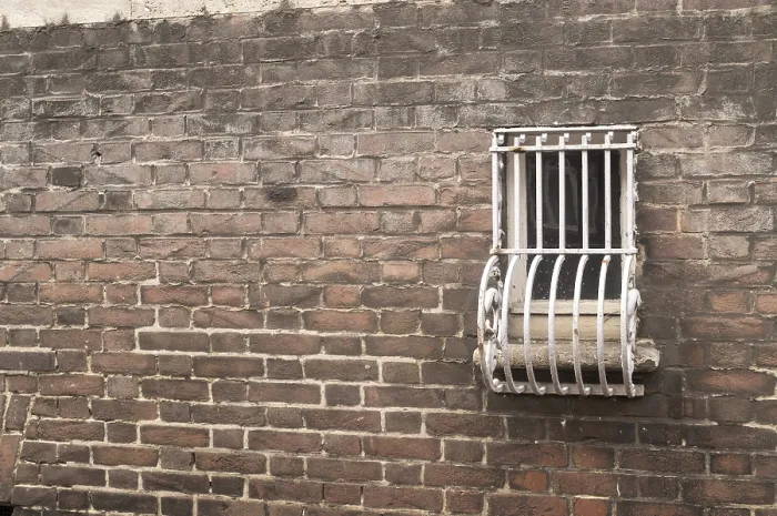 Framed Print : Barred small window on a brick wall Print