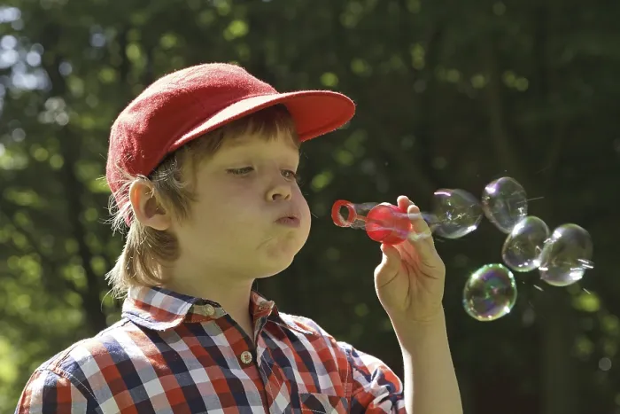 Framed Print : Boy Blowing Soap Bubbles Print