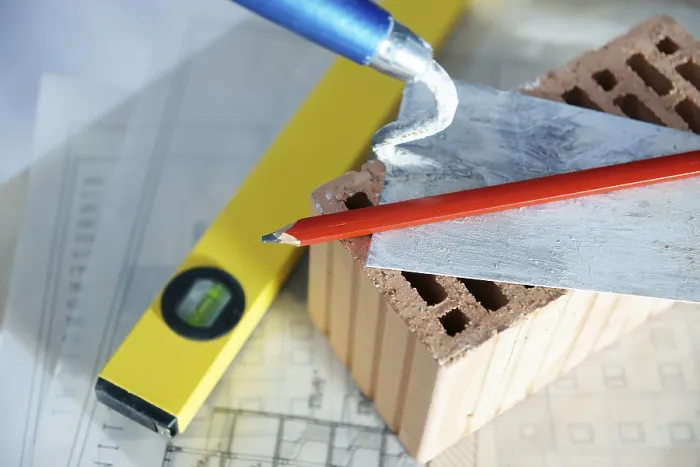 Framed Print : Brick Trowel and Brick Print on Construction Plan Framed Print : Brick Trowel and Brick Print on Construction Plan