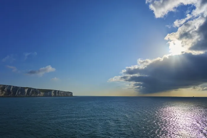 Framed Print : Brilliant sunlight through clouds over ocean and cliffs Print Framed Print : Brilliant sunlight through clouds over ocean and cliffs Print