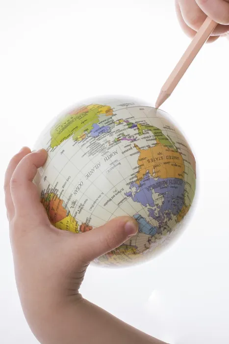Framed Print : Child holding a globe and pen print on white background Framed Print : Child holding a globe and pen print on white background