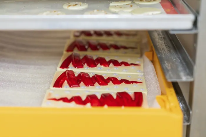 Framed Print : Chocolate Bars with Red Patterns in a Tray Print