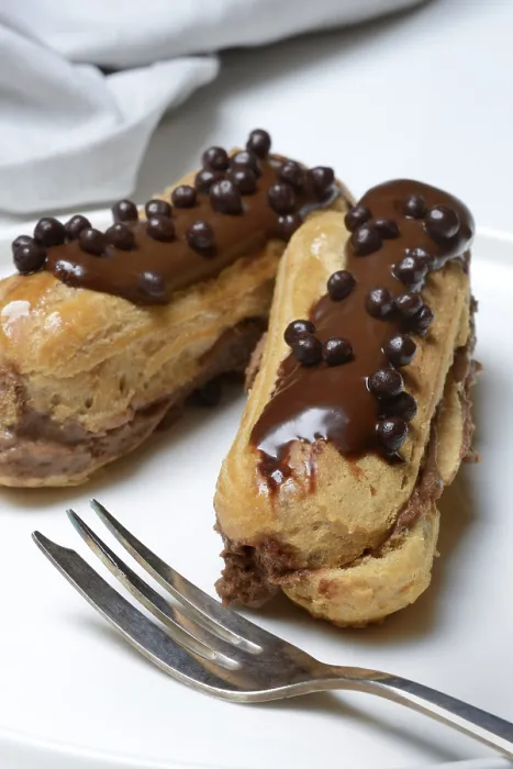 Framed Print : Two Chocolate Eclairs Print on Plate Framed Print : Two Chocolate Eclairs Print on Plate