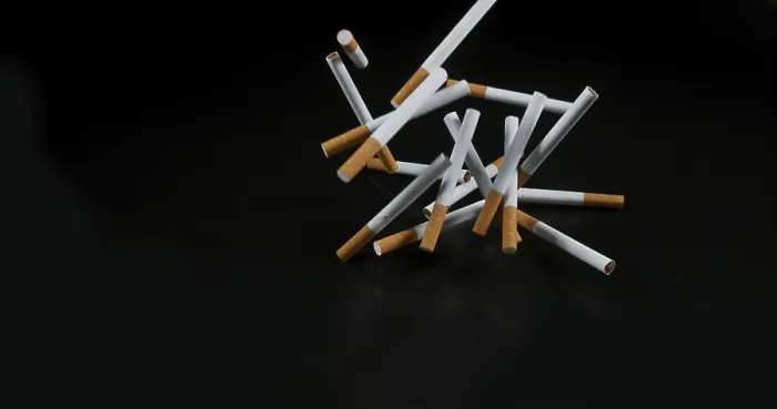 Framed Print : Cigarettes Falling Print against Black Background