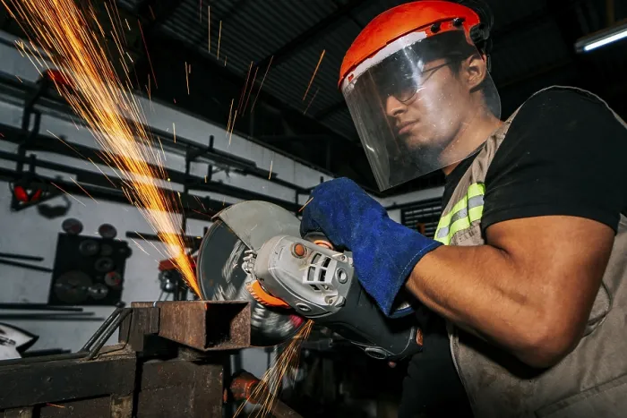 Framed Print : Close-up of a man using a grinder on an anvil Print Framed Print : Close-up of a man using a grinder on an anvil Print
