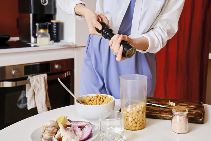 Framed Print : Closeup view of adding pepper into blender with chickpeas while making hummus print Framed Print : Closeup view of adding pepper into blender with chickpeas while making hummus print
