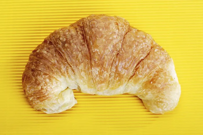 Framed Print : Croissant Print on Yellow Surface Framed Print : Croissant Print on Yellow Surface