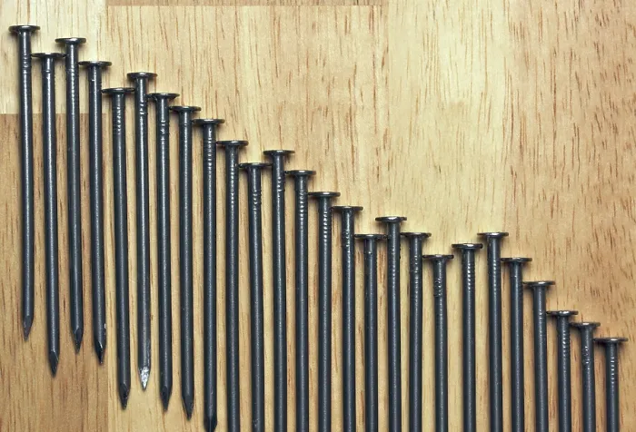 Framed Print : Declining Graph of Nails Print on Wood Background Framed Print : Declining Graph of Nails Print on Wood Background