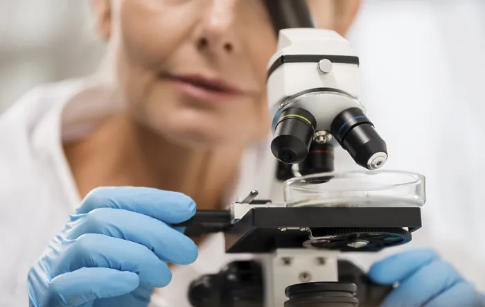 Framed Print : Defocused Female Scientist Looking Through Microscope Print Framed Print : Defocused Female Scientist Looking Through Microscope Print