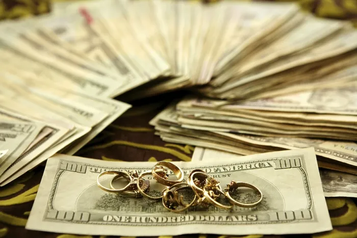 Framed Print : Print of Dollar Notes and Gold Rings over Tablecloth Framed Print : Print of Dollar Notes and Gold Rings over Tablecloth