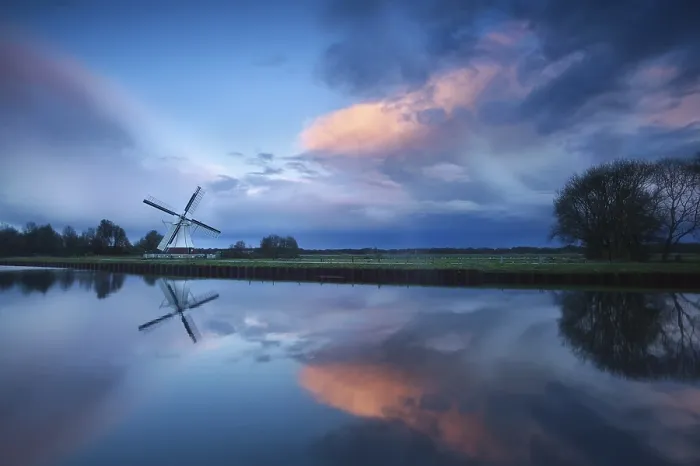 Framed Print : Dramatic Stormy Sunset Print over Dutch Windmill by River Framed Print : Dramatic Stormy Sunset Print over Dutch Windmill by River