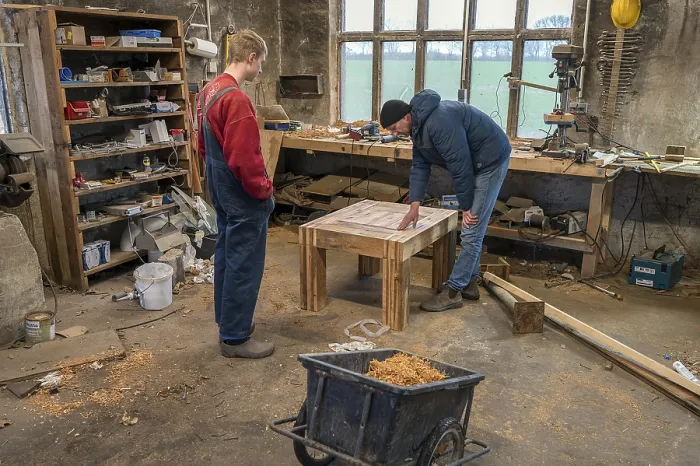 Framed Print : Father and Son Looking at a Handmade Table Print, Germany Framed Print : Father and Son Looking at a Handmade Table Print, Germany