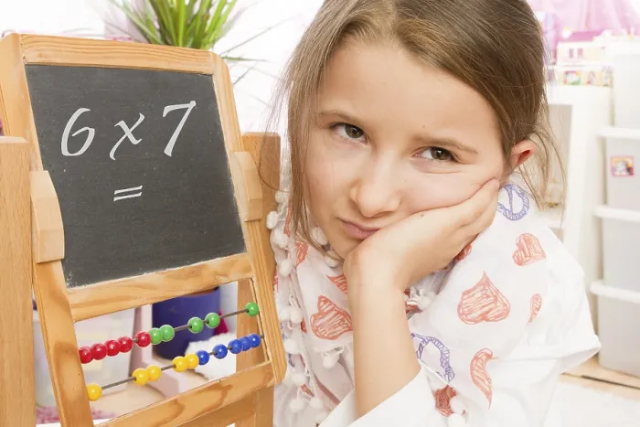 Framed Print : Frustrated 7-year-old girl in arithmetic class print Framed Print : Frustrated 7-year-old girl in arithmetic class print
